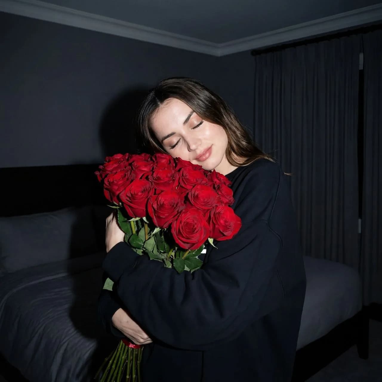 Woman holding a bouquet of red roses